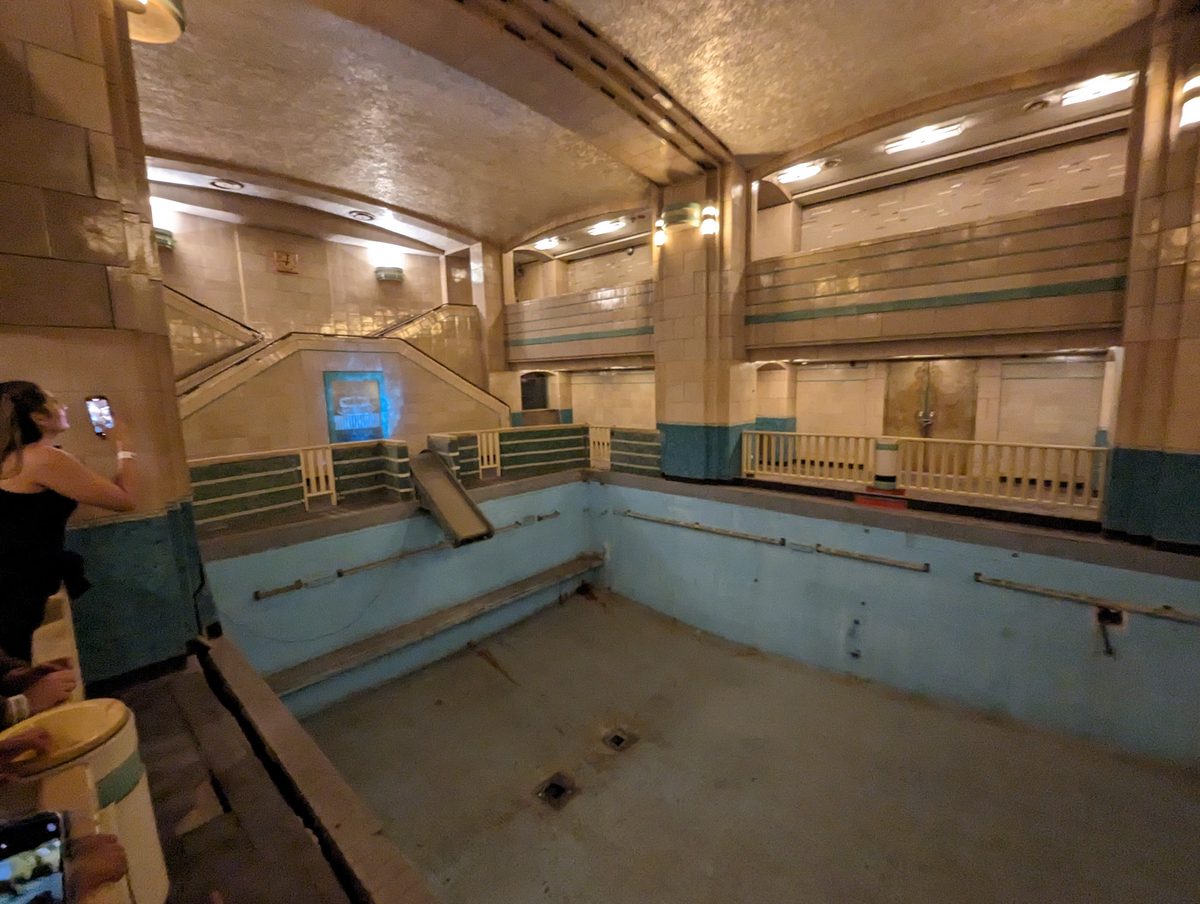 The Queen Mary's indoor Art Deco swimming pool — now drained, with multi-level tiled galleries and balconies