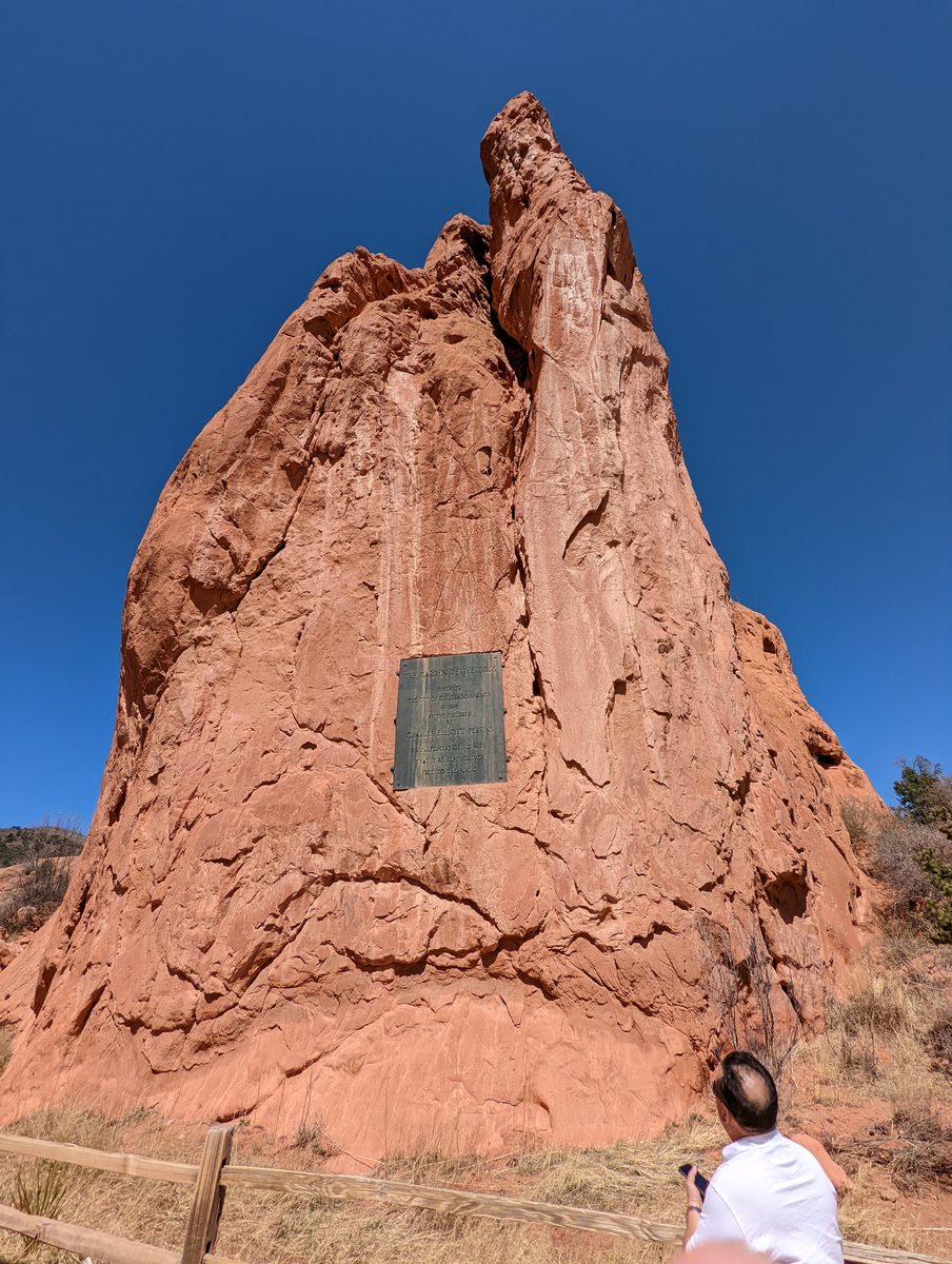 Looking up at the Gateway Rocks formation with a bronze dedication plaque mounted on the rock face