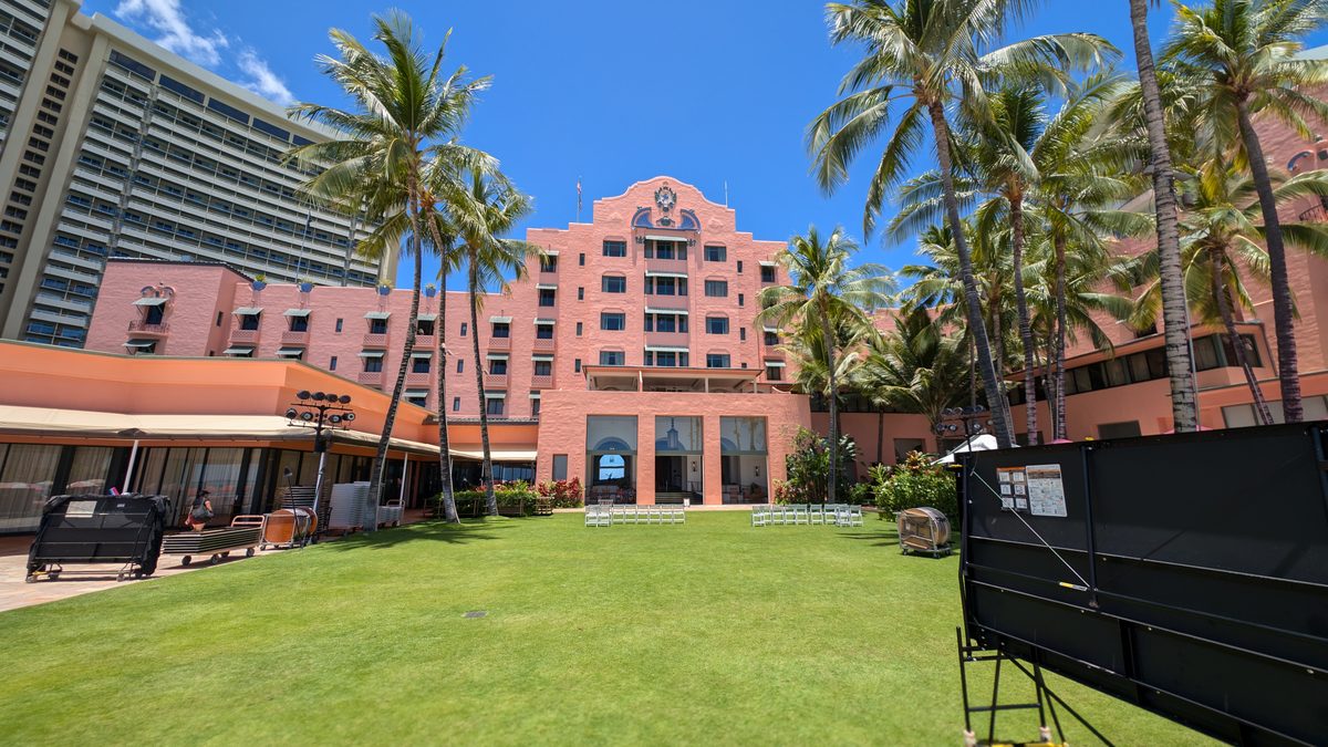 The Royal Hawaiian hotel — the iconic coral-pink Spanish-Moorish facade behind its manicured lawn and palm trees