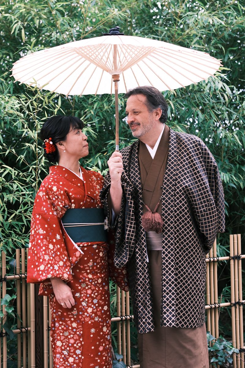 Ako and Eddy looking at each other in the bamboo garden, Eddy holding a white wagasa parasol