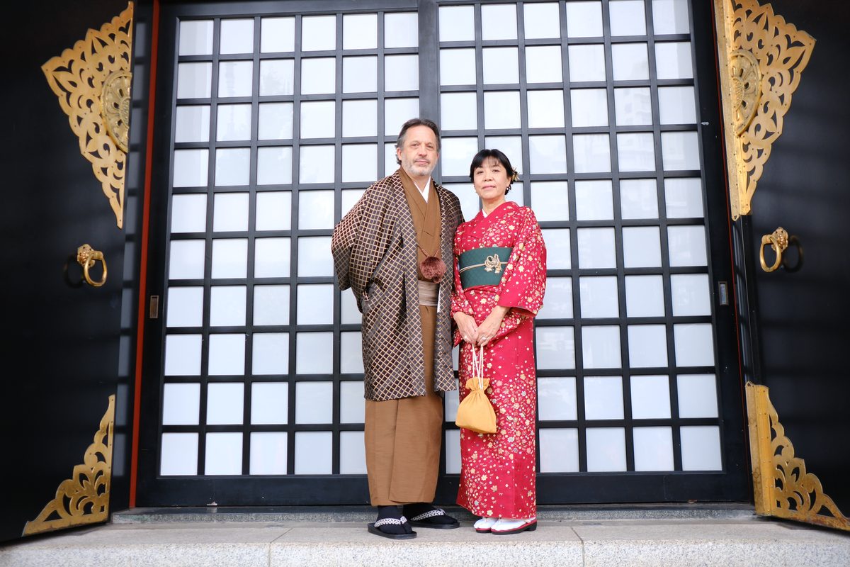 Wide shot of Eddy and Ako with the Sensoji five-story pagoda visible rising above the temple complex