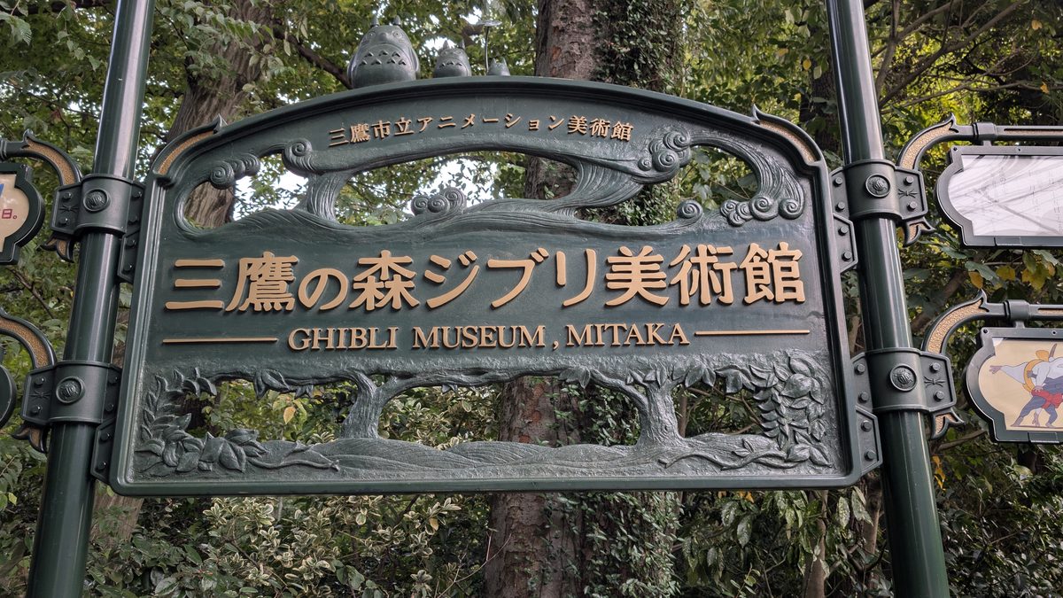 The hand-cast bronze Ghibli Museum sign at the edge of Inokashira Park