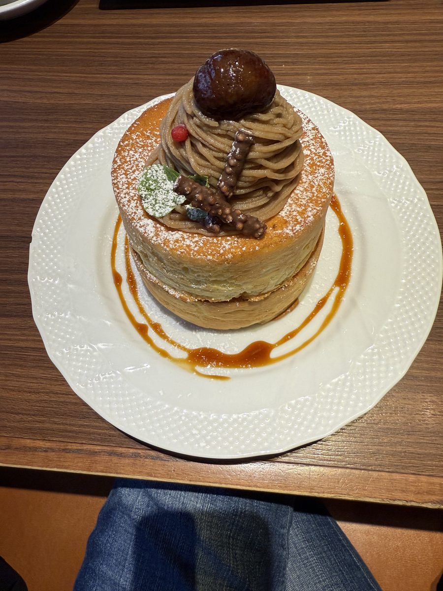 A chestnut Mont Blanc dessert on a white plate with caramel