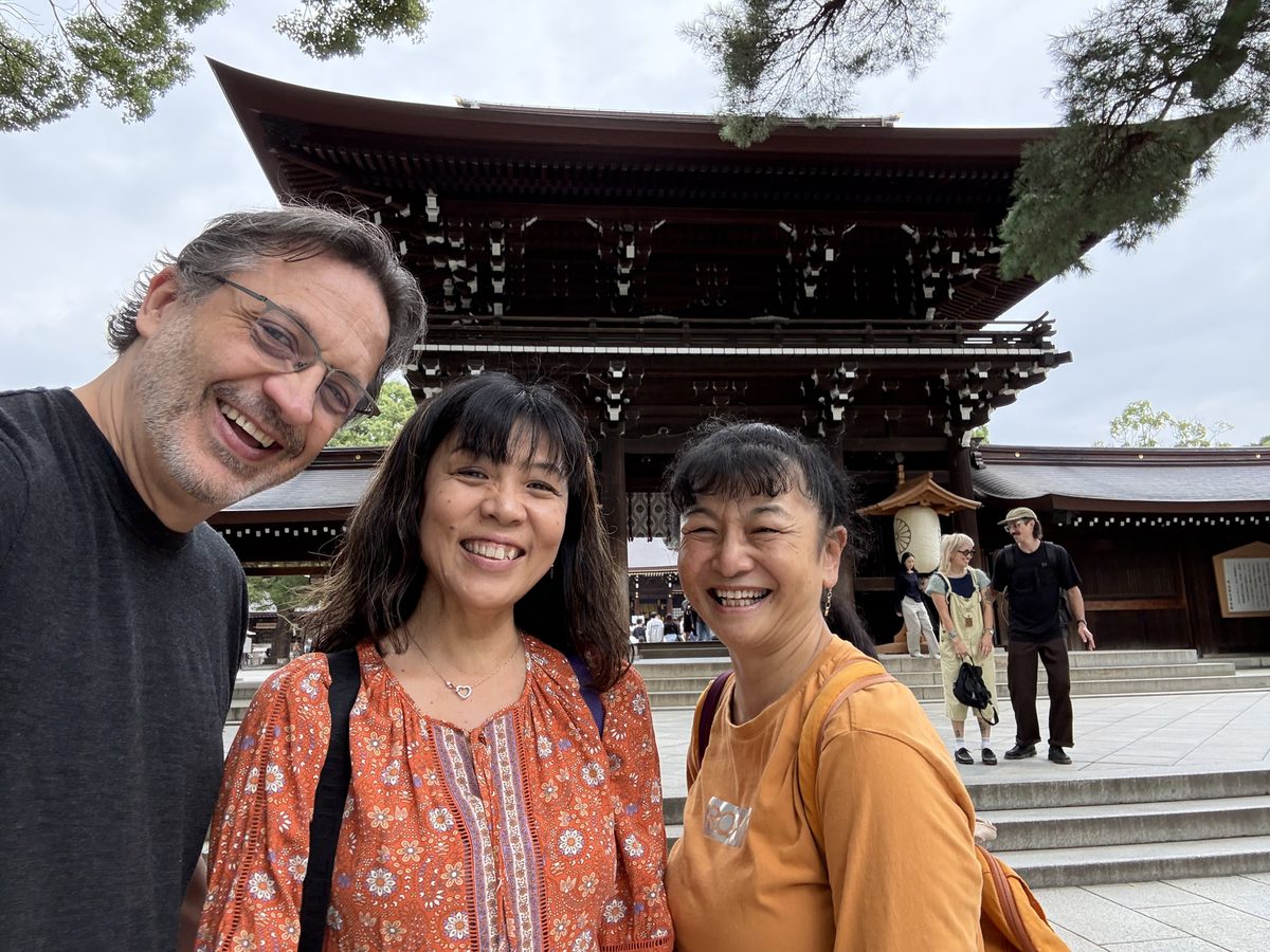 Eddy, Ako and a friend laughing together in front of the Romon gate