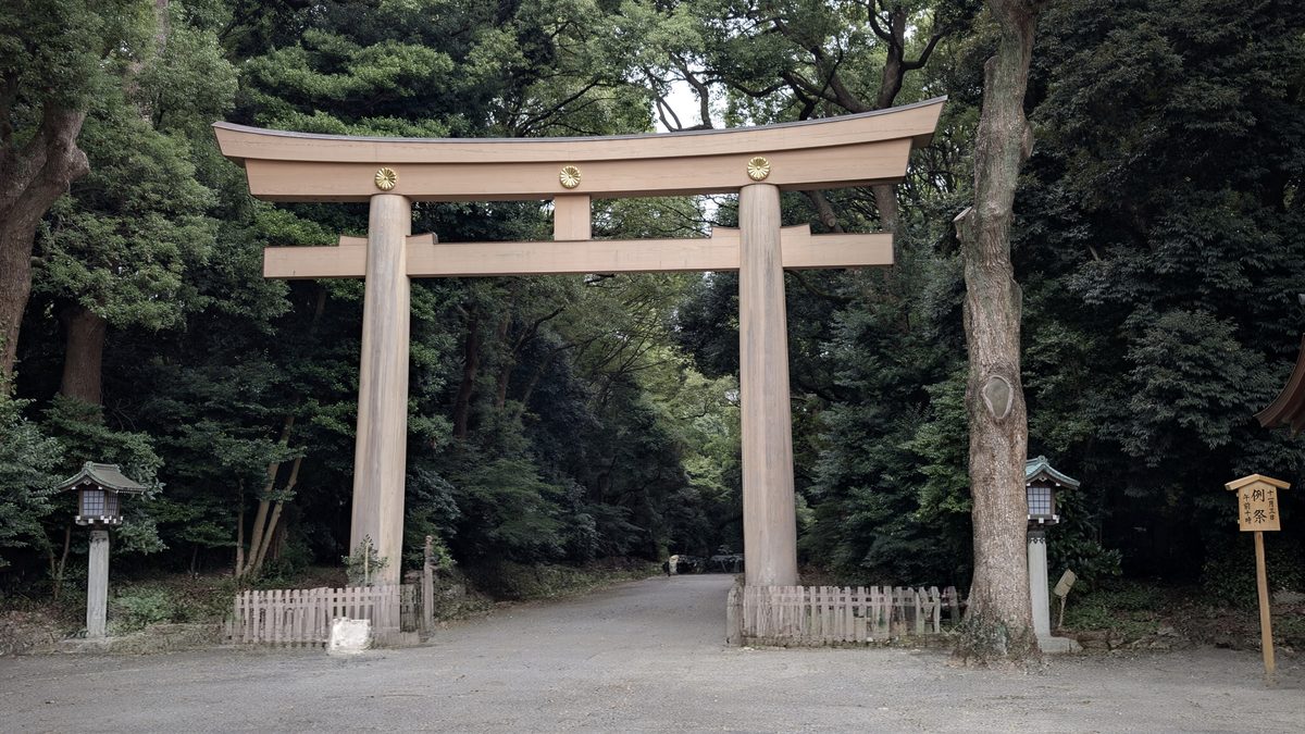 The great wooden cypress otorii gate over the forest approach path