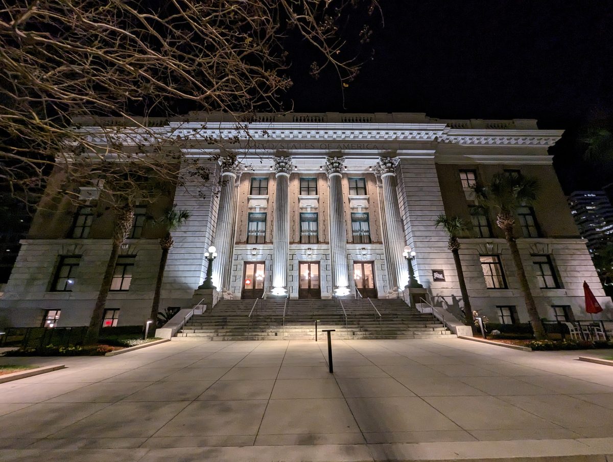 The columned neoclassical facade of Le Meridien Tampa lit up at night